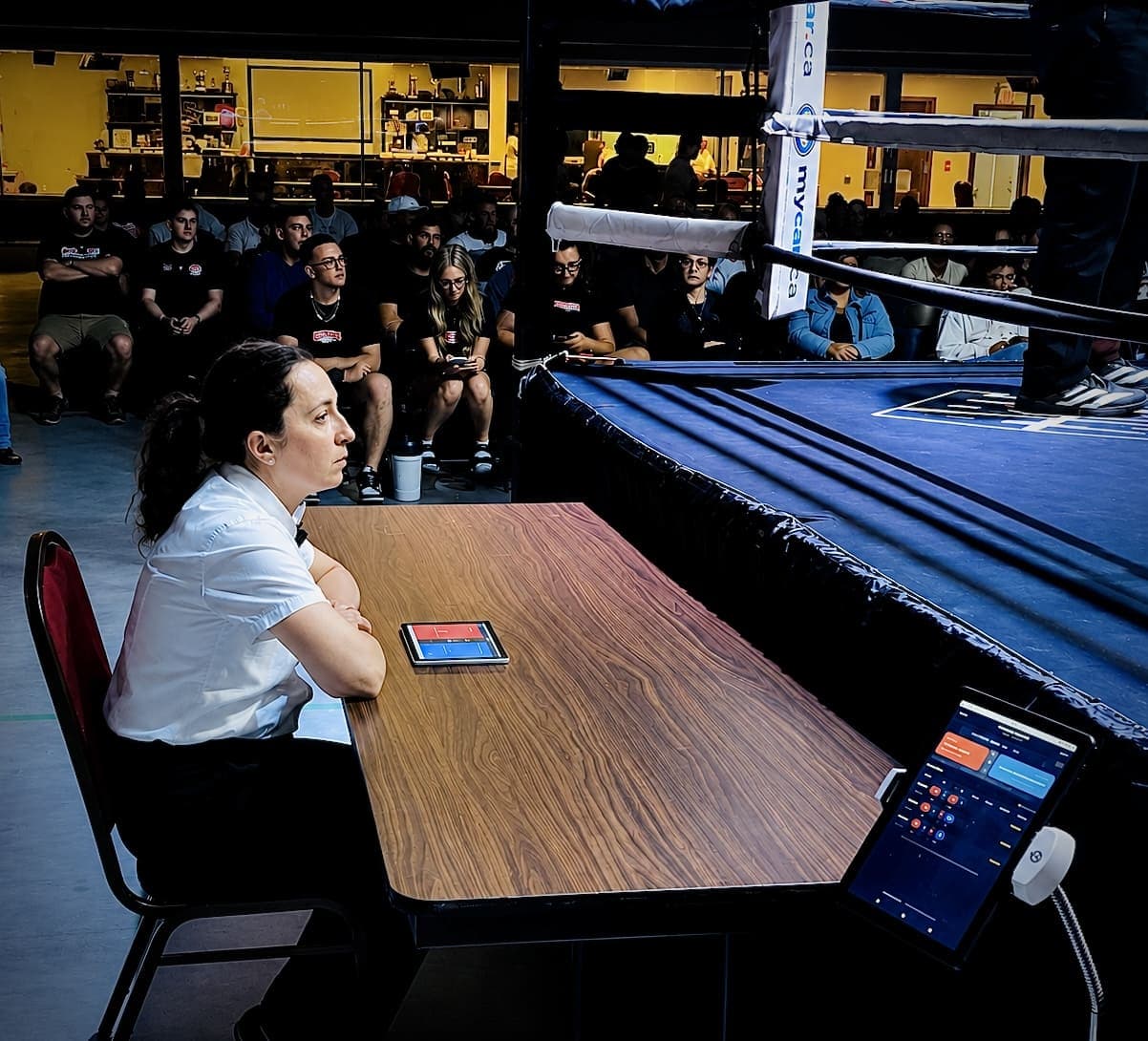 A RingScore scoring device used beside a boxing ring.